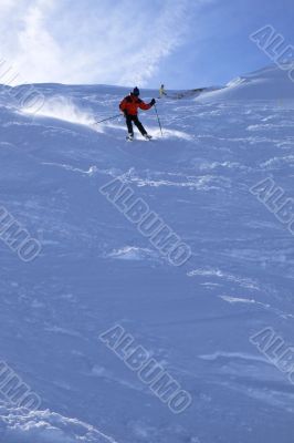 Red skier in powder snow,