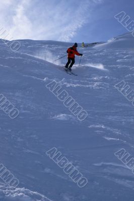 Red skier in powder snow,