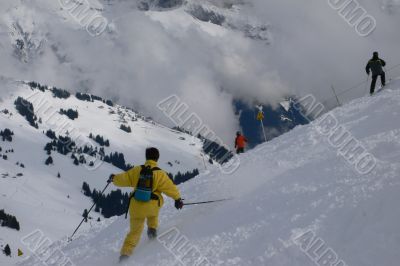 Yellow skier traversing steep slope