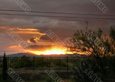  Sun setting  into the Rain Clouds