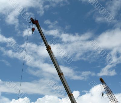 Double construction crane against blue sky