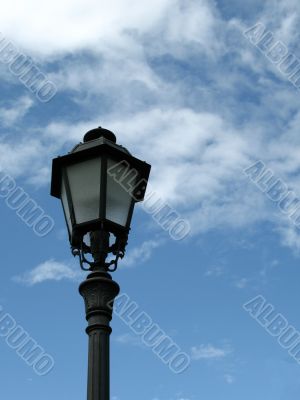 Single lamp post against blue sky