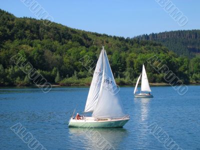 Two little yachts on water