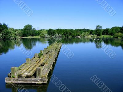 Very clear blue water with sky and a strange pier