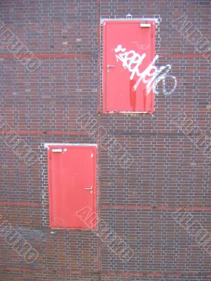 Two doors in brick wall
