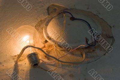 Lit electric bulb on the wall