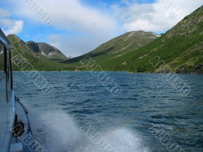View of Gjende lake from the deck of a boat