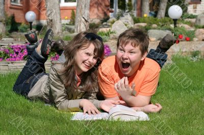 smiling boy and girl with a book