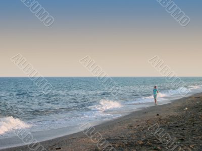 Walking single woman on beach