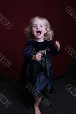 happy little girl in party dress with toy