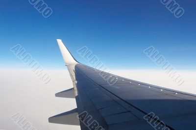 Airplane wing above the clouds