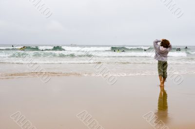 girl looking at surfers