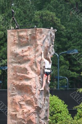 Woman Climbing Wall