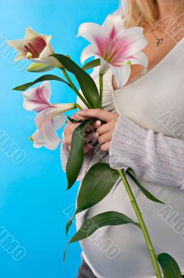 pregnant woman`s belly and lily