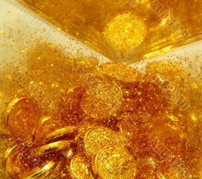 Gold sand and gold coins  close-up