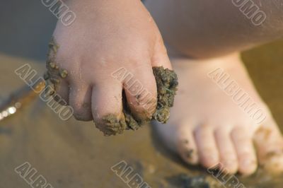 child`s hand with sand