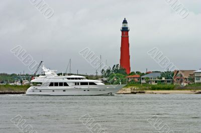 luxury yacht near lighthouse