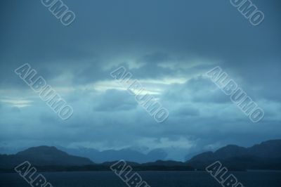 Dark clouds, shadowy blue ridges