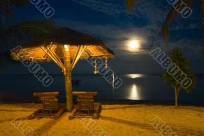 beach chairs at tropical resort - night scene