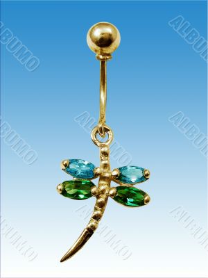Piercing in form dragonfly on blue background