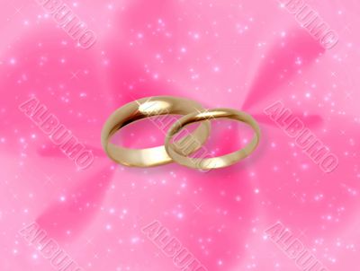 Wedding rings on pink fantasy background