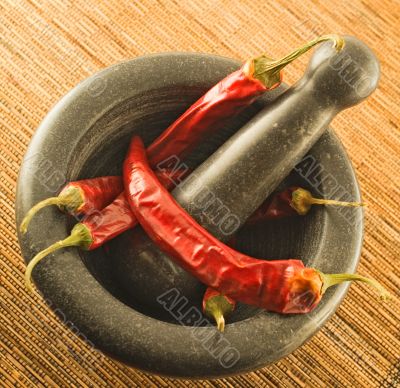 stone mortar with red chillies