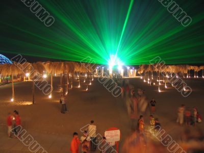 The green laser at night above a beach