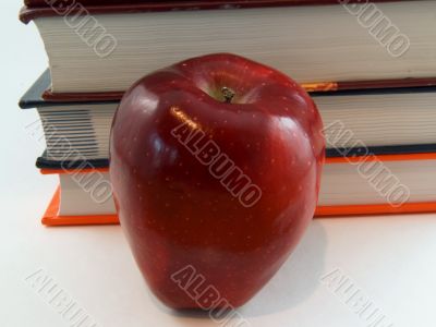 Big Apple in front of books