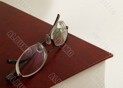 Book with pair of glasses on top