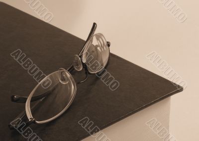 Book with pair of glasses on top