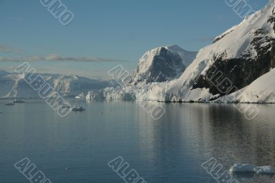 Mountains & glaciers reflected in calm ocean