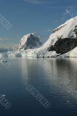Mountains & glaciers reflected in calm ocean