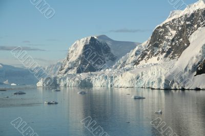 Mountains & glaciers reflected in calm ocean