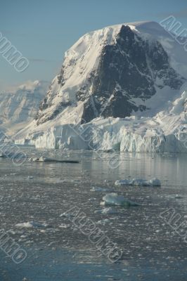 Mountains & glaciers reflected in calm ocean