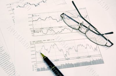 graphs, pen and glasses
