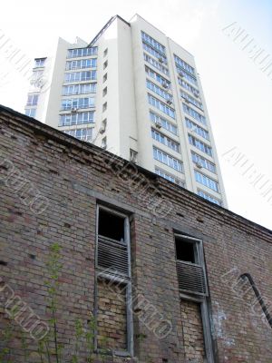 Old house against modern office buildings