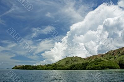 blue sky, white clouds and green island