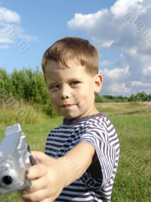 Little boy with toy-pistol