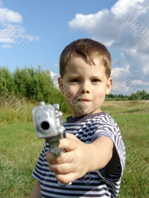 Little boy with toy-pistol