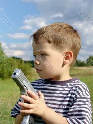 Little boy with toy-pistol