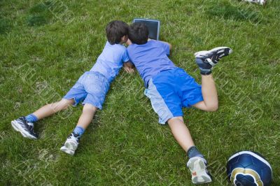 Two cute boy study on computer