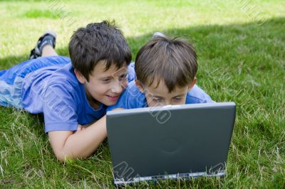 Two cute boy study on computer