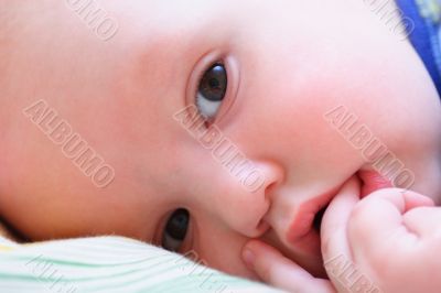 Baby`s face looks at camera close up
