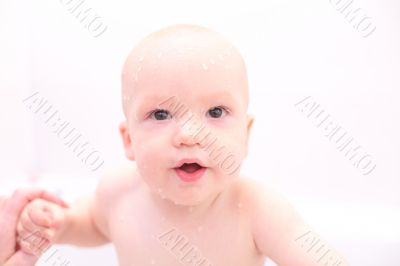 Baby in bath with toys