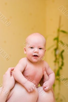 Mother holding on laps enjoying baby