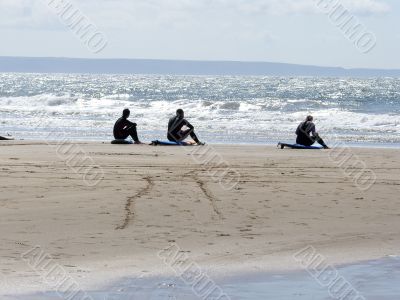 Three Surfers