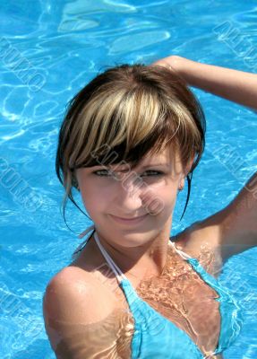 Young beautiful girls on a pool