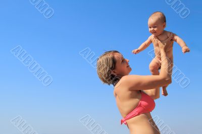 Mother lifting her daughter