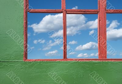 blue coudy sky through old house window