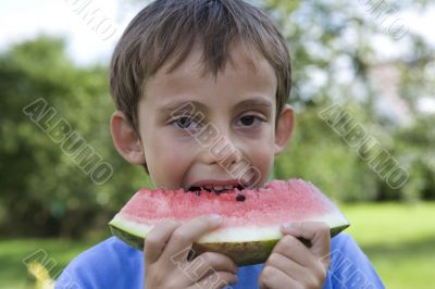 Boy eats watermelon